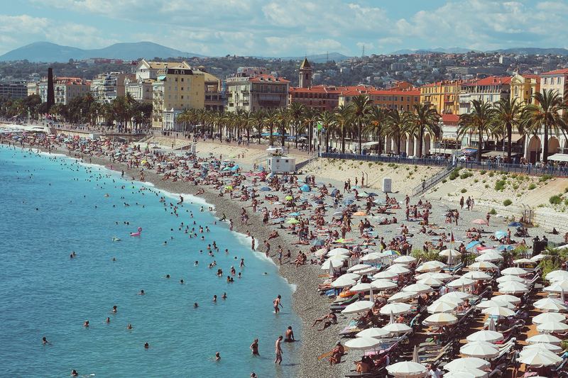 A Nice beach with rows of white parasols and turquoise sea